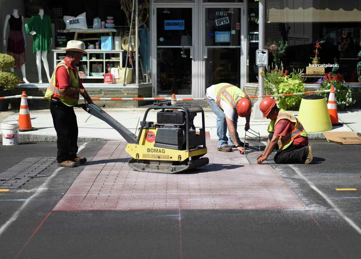 Construction workers install a new brick sidewalk on Sound Beach Avenue in Old Greenwich, Conn. Thursday, Aug. 22, 2019. Projects like this one, as well as any future projects, are now being listed on an interactive Department of Public Works map on the town’s website. Information about the projects as well as where there are road closures and detours are listed for all DPW projects.