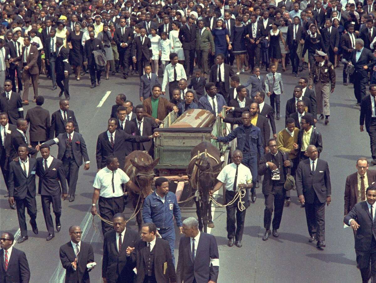 The funeral procession for Martin Luther King Jr., in Atlanta, Ga., April 9, 1968. Just before his assasination, King invoked the gospel classic, “Precious Lord, Take My Hand.” Some songs are timeless and borderless.