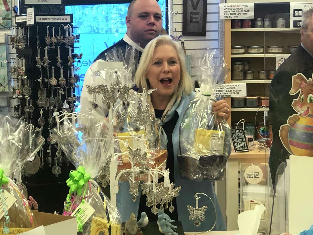 U.S. Sen. Kirsten Gillibrand buys some homemade Easter baskets at Marra's Pharmacy in Cohoes after her press conference on how to combat high drug prices in the U.S.