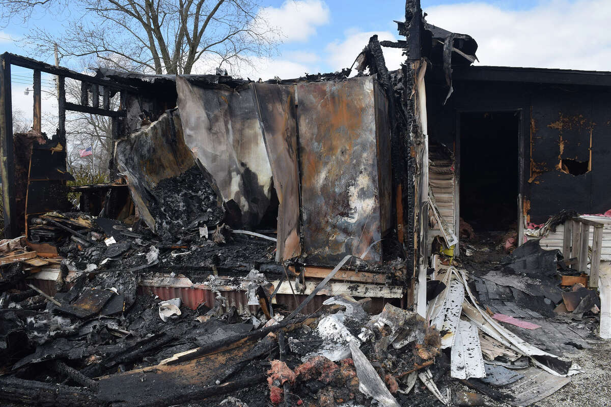 Two people died Thursday when fire tore through a house on Green Street in Greenfield. Two police officers who tried to rescue those inside the house were injured, and one of the residents who escaped the blaze was treated for smoke inhalation.