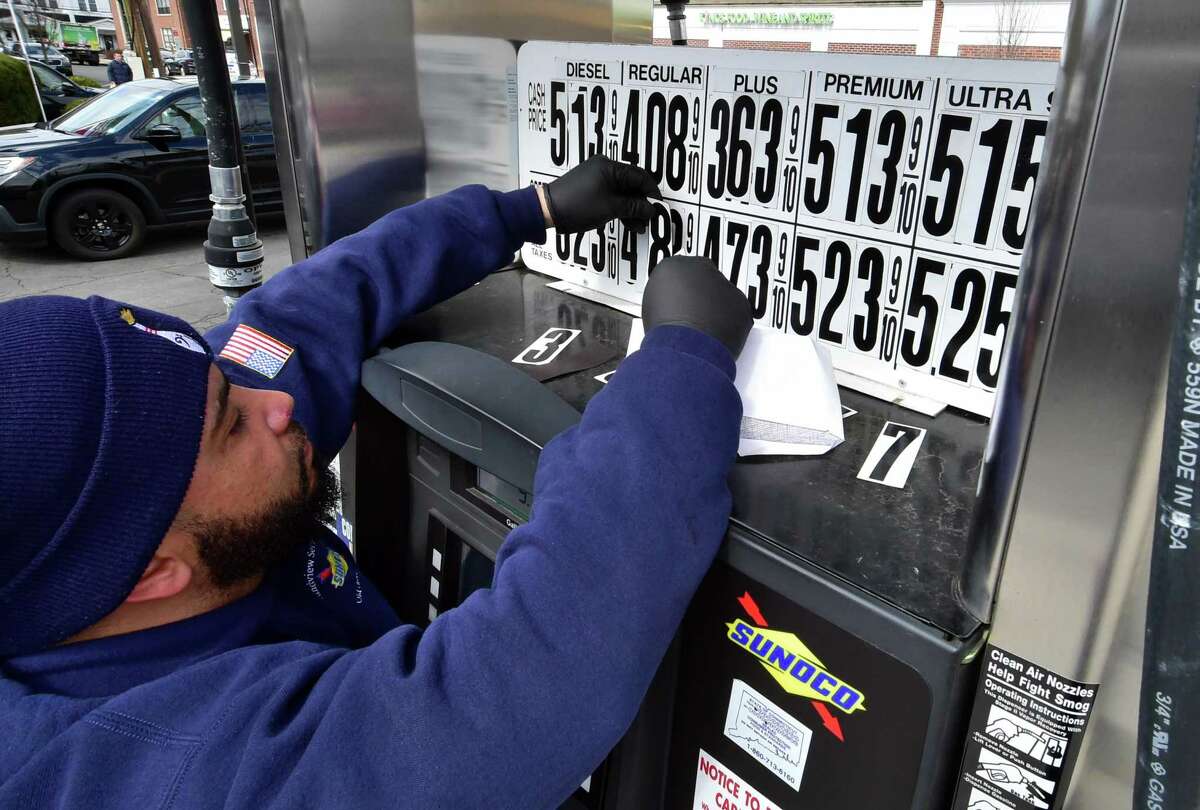 Joseph Parente changes the prices at the pump at Soundview Servicenter North in Old Greenwich Friday. , Conn., on Friday April 1, 2022. The state's gas tax holiday is in effect today, bring prices down 25 cents per gallon.