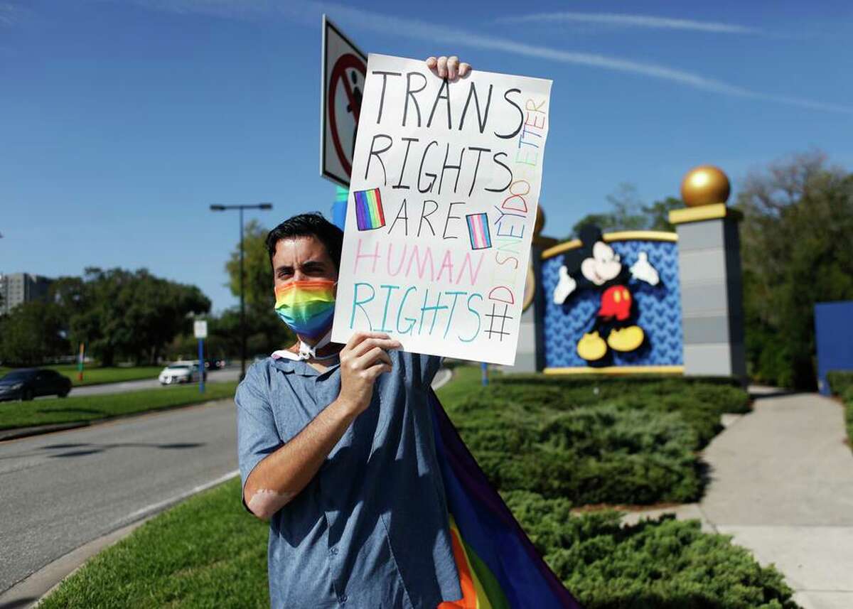 Disney employee Nicholas Maldonado protests Florida’s “Don’t Say Gay” legislation outside of Orlando’s Disney World.