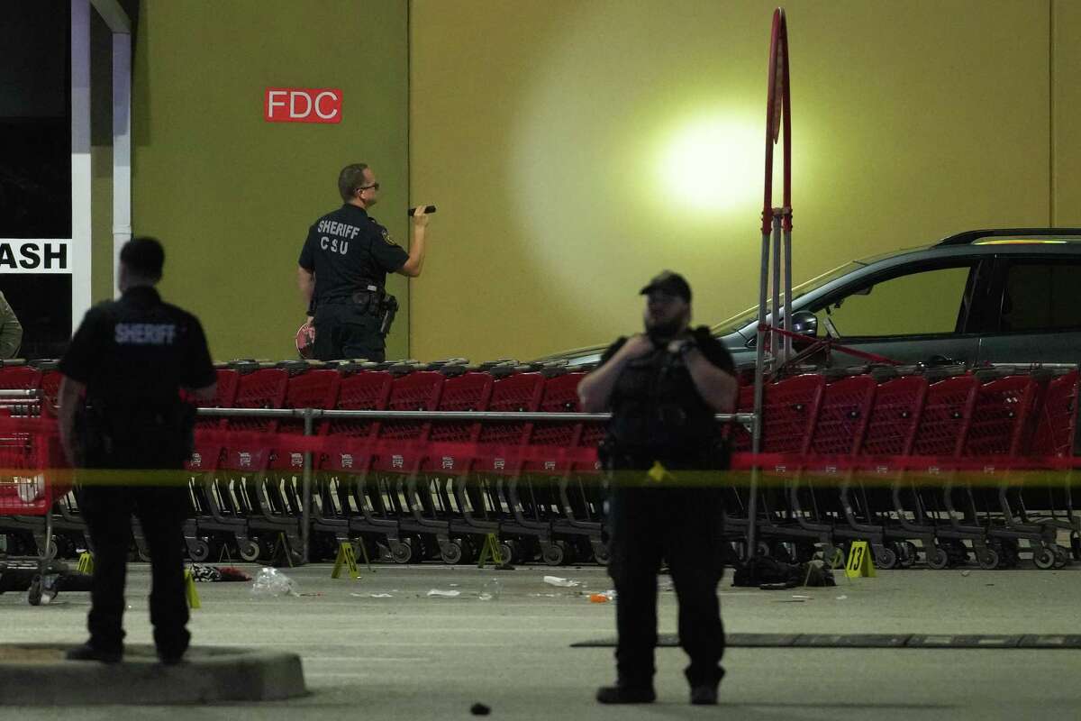 Law enforcement officers investigate the scene of an officer-involved shooting in the parking lot of a grocer store at 2929 FM 1960 near Aldine Westfield Thursday, March 31, 2022 in Houston. An off-duty Harris County Sheriff's Office deputy was shot in north Harris County when gunfire broke out between the deputy and people “committing a criminal offense,” according to Sheriff Ed Gonzalez. The sheriff wrote in a tweet that, “as the deputy approached, the males opened fire and our deputy returned fire.” The deputy, who was struck, was transported in critical condition, Gonzalez wrote. ( Brett Coomer / Houston Chronicle )
