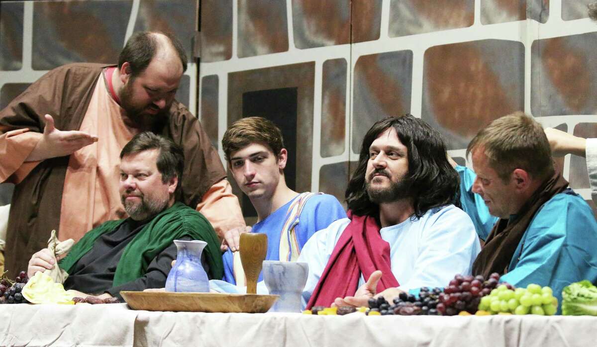 Disciples Ryan Howard (Peter), Sean Corcoran (Judas), Brenden ReBeau (John), Pastor Tony Kobak (Jesus), and Nelbert Krause (James) eat fruit and vegetables while chatting moments before the institution of the Last Supper.