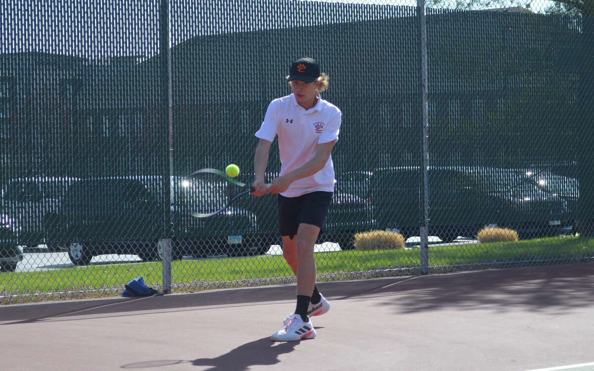 Colton Hulme in action against Maine South on Friday at the Edwardsville Tennis Center. 
