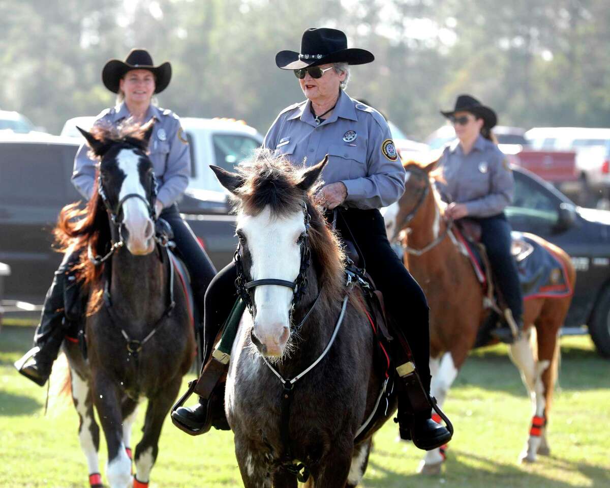 Marilyn Kinney, second from left, leads a members of the Montgomery County Precinct 2 Constable’s Mounted Posse for another evening at the Montgomery County Fair and Rodeo, Friday, April 1, 2022, in Conroe. The 15-member volunteer group adds to law enforcement surveillance efforts at the fairgrounds during some of the rodeo and fair’s busiest days.