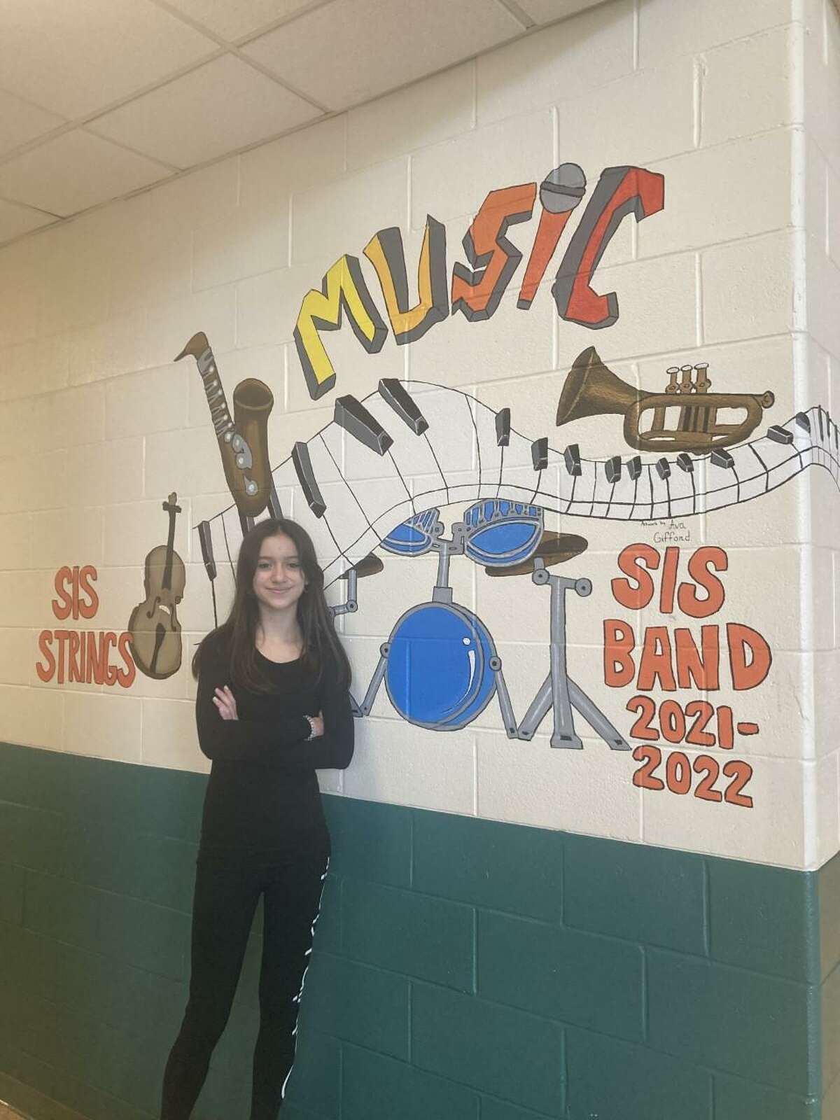 Shelton Intermediate School student Ava Gifford’s mural design was selected from among 40 entries submitted this past winter by art and music students. Her mural was painted on the walls entering the music section of the school.