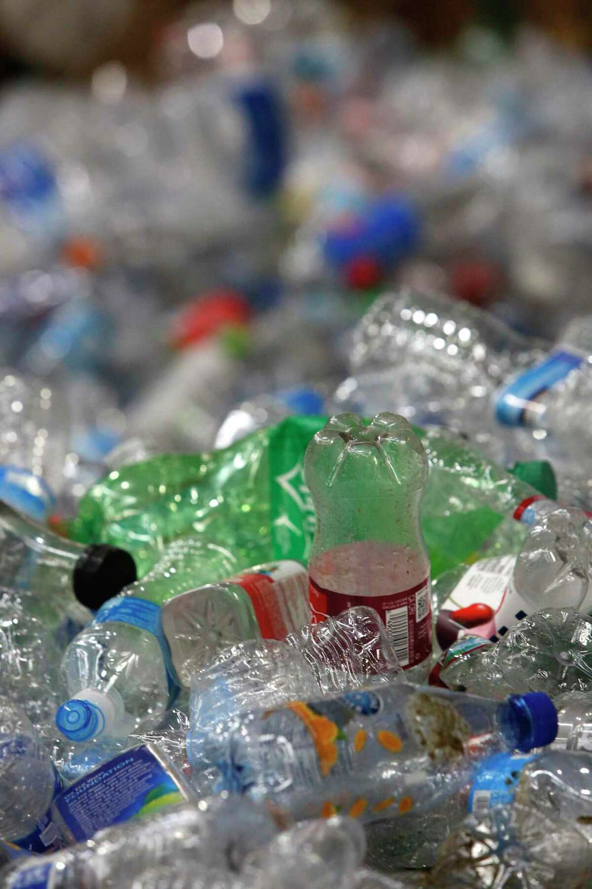 Plastic bottles are seen in piles before they are baled together at Recology's Recycle Central on Monday, September 30, 2019 in San Francisco, CA.
