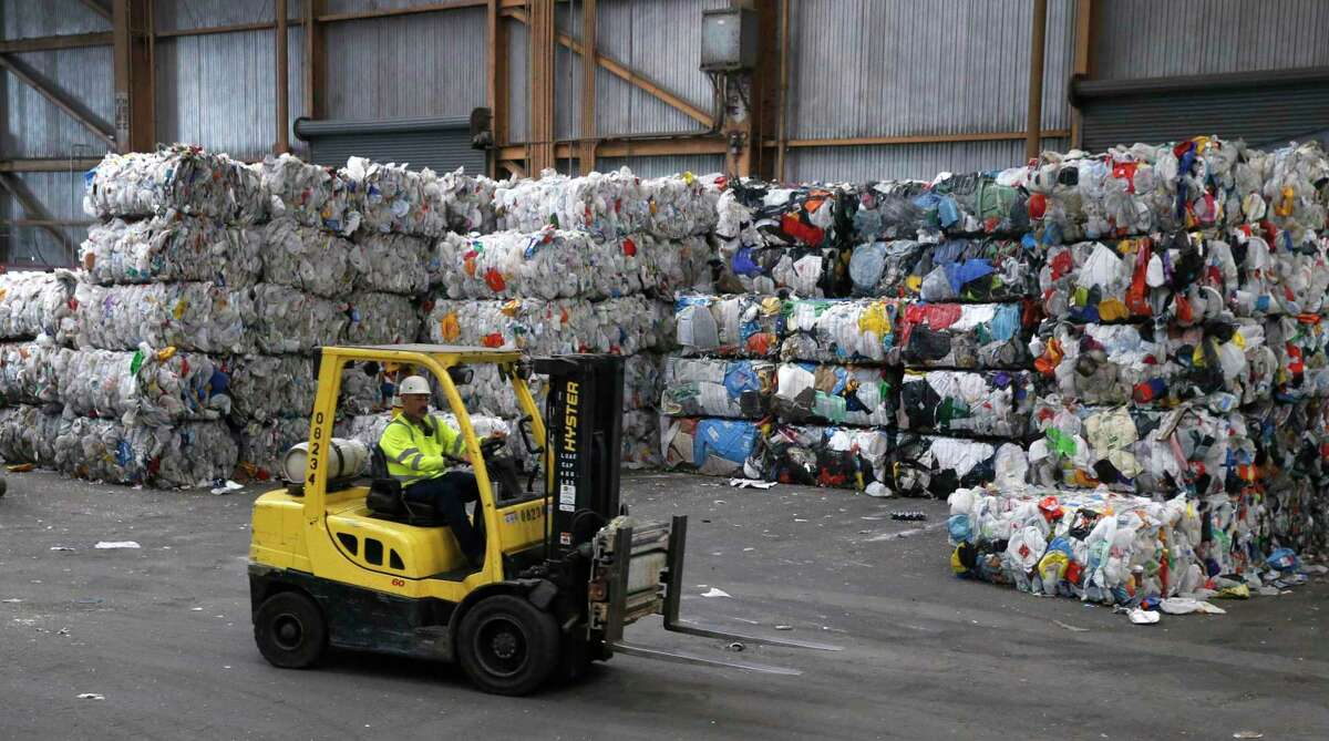 Large bales of plastic bottles and containers are stacked and await transfer away from the Recology recycling facility in San Francisco, Calif. on Thursday, Aug. 22, 2019.