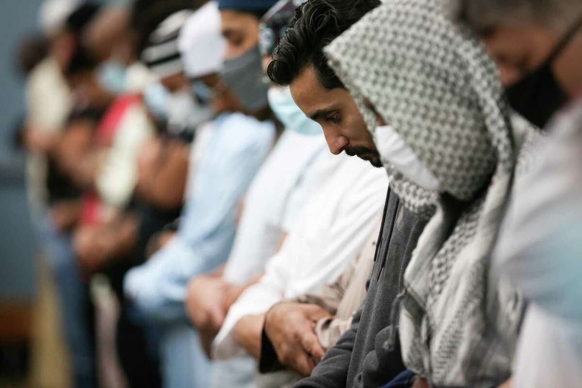 Men pray Friday, April 1, 2022, at Masjid Bilal in Houston. The mosque shares a building with Darul Arqam Academy North.