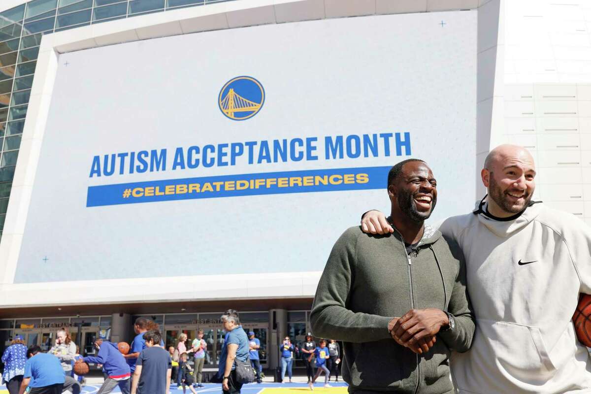 From left: Draymond Green and Anthony Ianni laugh while being interviewed, Friday, April 1, 2022, in San Francisco, Calif. Green of the Golden State Warriors held the autism awareness event at Thrive City, the plaza surrounding the center, alongside his former MSU teammate Ianni, who is on the autism spectrum. The event was in partnership with the Autism Society of S.F.