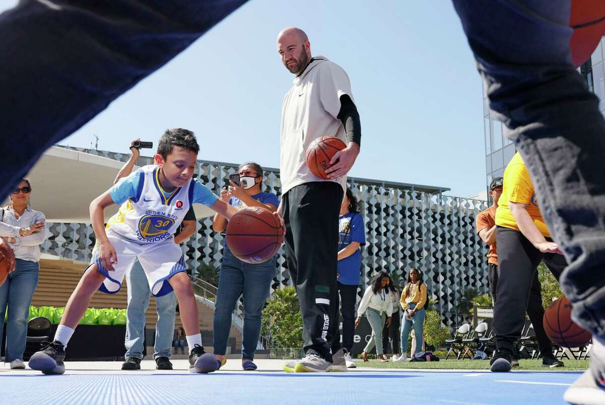 Anthony Ianni (center) as 9-year-old Nolan Amador and other children perform drills. Ianni, who is on the autism spectrum, played with Green in college.