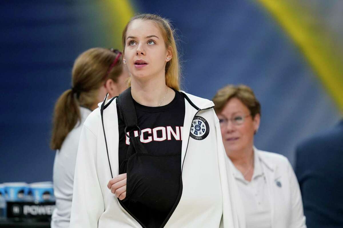 UConn's Dorka Juhasz is seen in a sling before a college basketball game in the semifinal round of the Women's Final Four NCAA tournament Friday, April 1, 2022, in Minneapolis. (AP Photo/Charlie Neibergall)