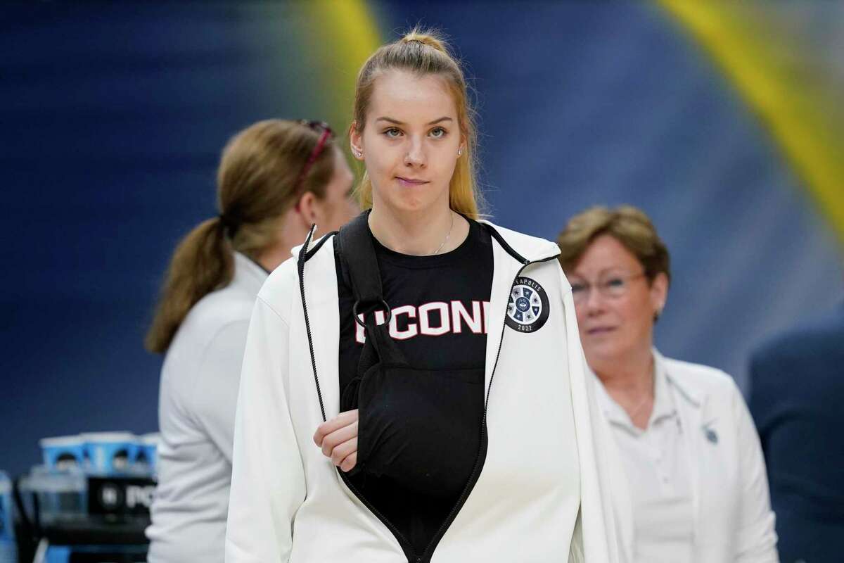 UConn's Dorka Juhasz is seen in a sling before a college basketball game in the semifinal round of the Women's Final Four NCAA tournament Friday, April 1, 2022, in Minneapolis. (AP Photo/Charlie Neibergall)