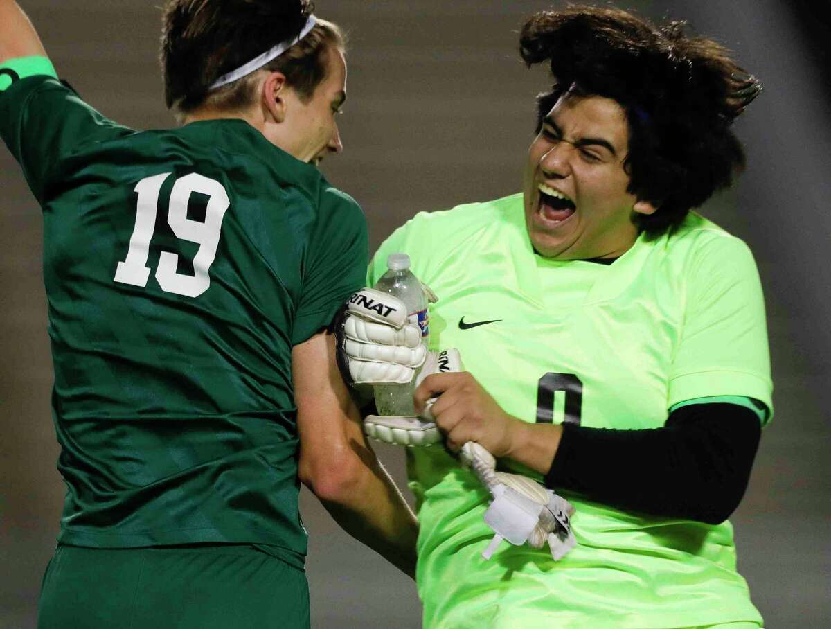 The Woodlands goalie Noah Shepard (0) celebrates with Max Coady (19) after defeating Bridgeland 1-0 in the second period of a Region II-6A quarterfinal high school playoff soccer match at Woodforest Bank Stadium, Friday, April 1, 2022, in Shenandoah.