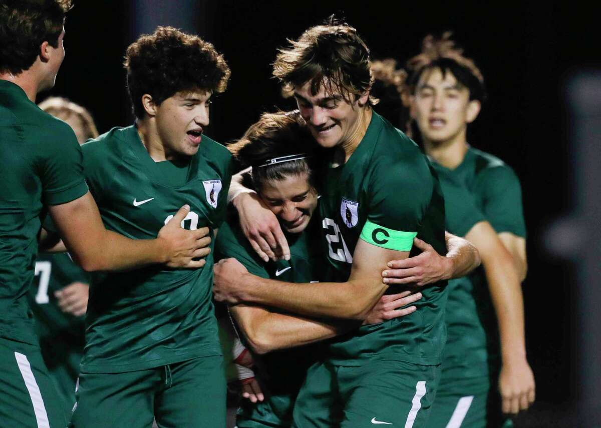 The Woodlands' Luis Quiros, center, celebrates with teammates after his first period goal gave the Highlanders a 1-0 advantage over Bridgeland during a Region II-6A quarterfinal high school playoff soccer match at Woodforest Bank Stadium, Friday, April 1, 2022, in Shenandoah.