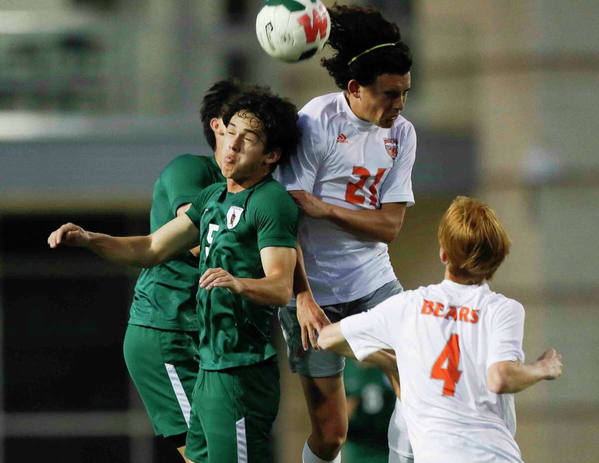 The Woodlands’ Reinaldo Perera (5) goes up for a header against Bridgeland's Eliseo Hernandez (21) in the first period of a Region II-6A quarterfinal high school playoff soccer match at Woodforest Bank Stadium, Friday, April 1, 2022, in Shenandoah.