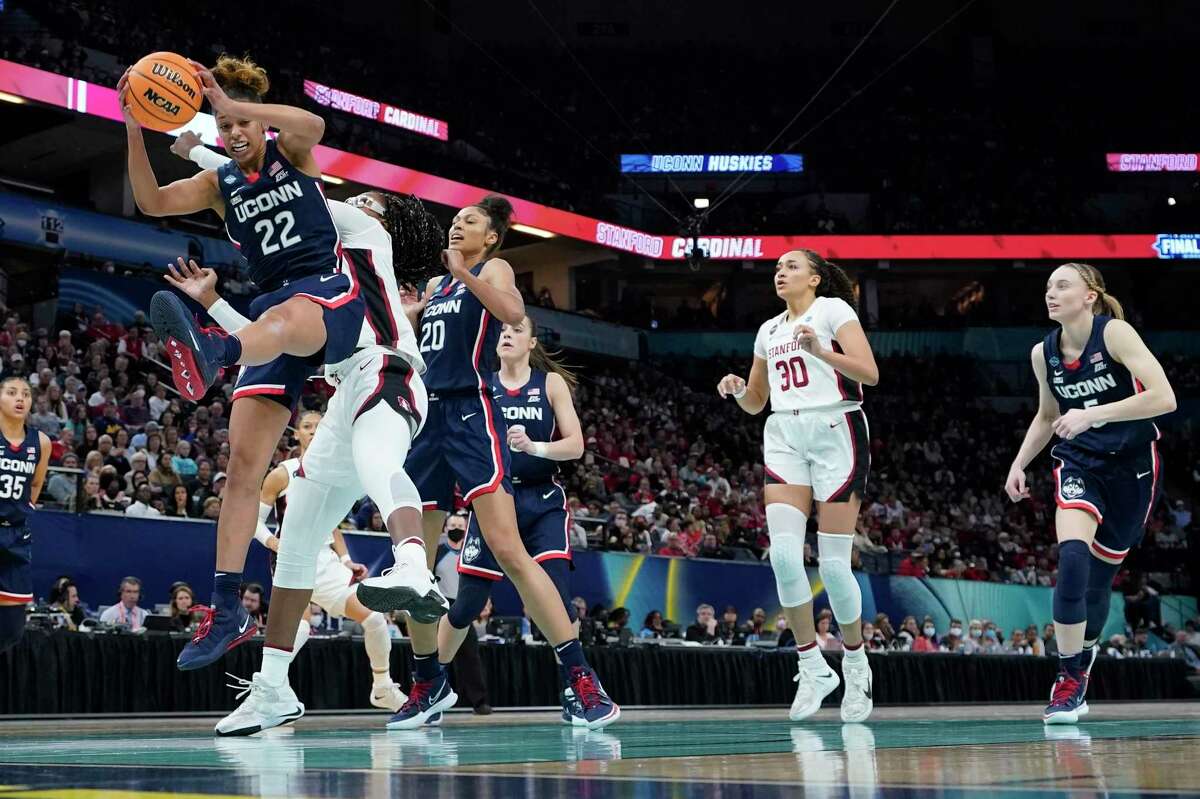 UConn's Evina Westbrook grabs a rebound in front of Stanford's Francesca Belibi during the first half of a college basketball game in the semifinal round of the Women's Final Four NCAA tournament Friday, April 1, 2022, in Minneapolis. (AP Photo/Eric Gay)