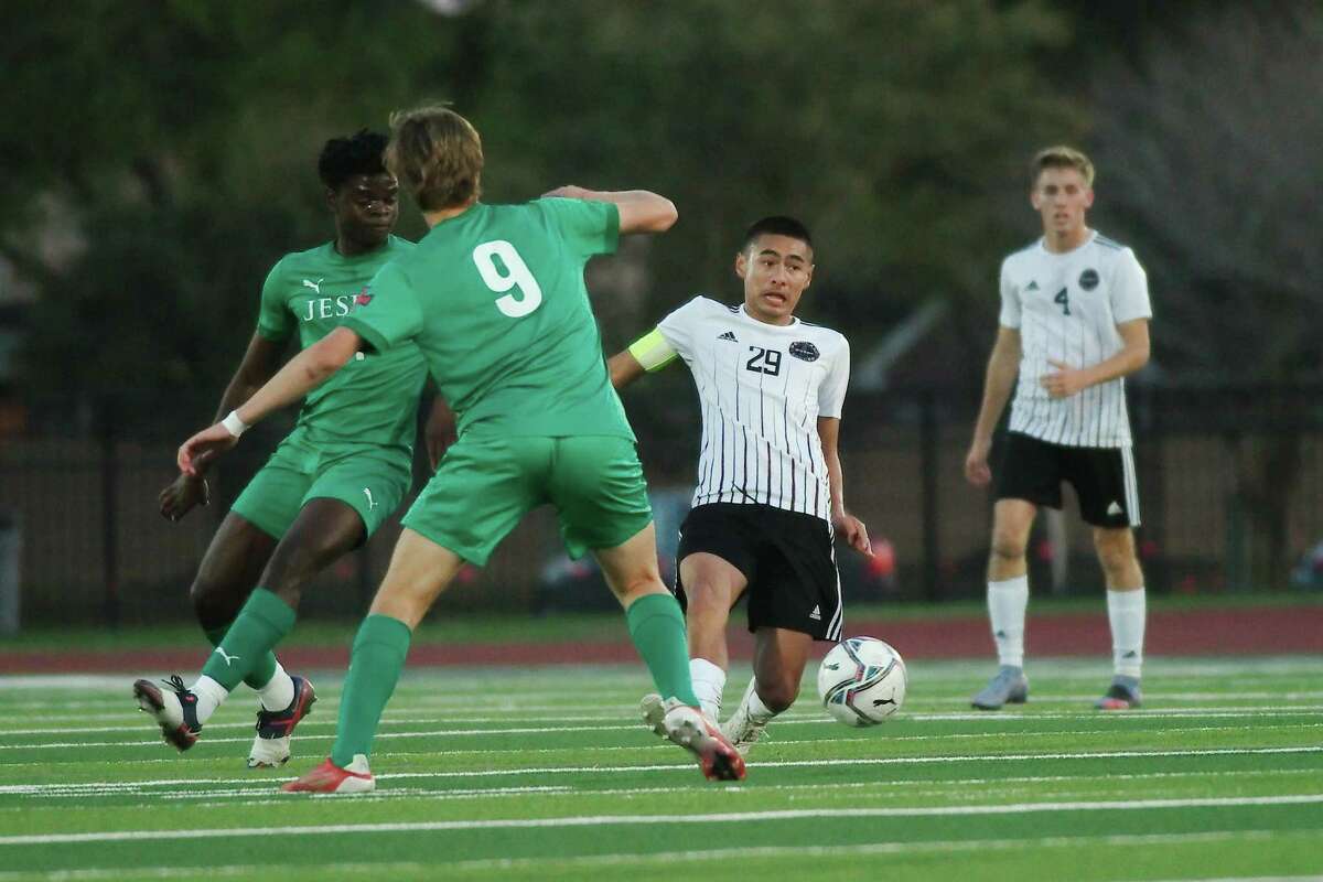 Pearland's Carlos Galan (29) works the ball past Strake Jesuit's Chase Anderson (9) Friday, Apr. 1, 2022 at Pearland High School.