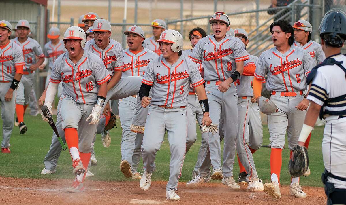 United High School’s baseball team cheers after a home run during a game against Alexander High School, Friday, April 1, 2022 at the UISD Student Activity Complex.