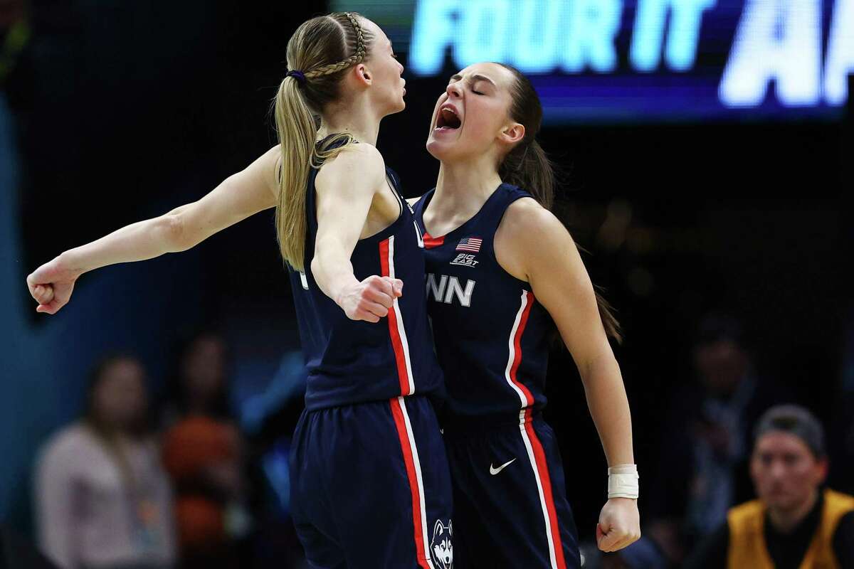MINNEAPOLIS, MINNESOTA - APRIL 01: Paige Bueckers #5 and Nika Muhl #10 of the UConn Huskies celebrate in the second quarter against the Stanford Cardinal during the 2022 NCAA Women's Final Four semifinal game 2 at Target Center on April 01, 2022 in Minneapolis, Minnesota. (Photo by Elsa/Getty Images)