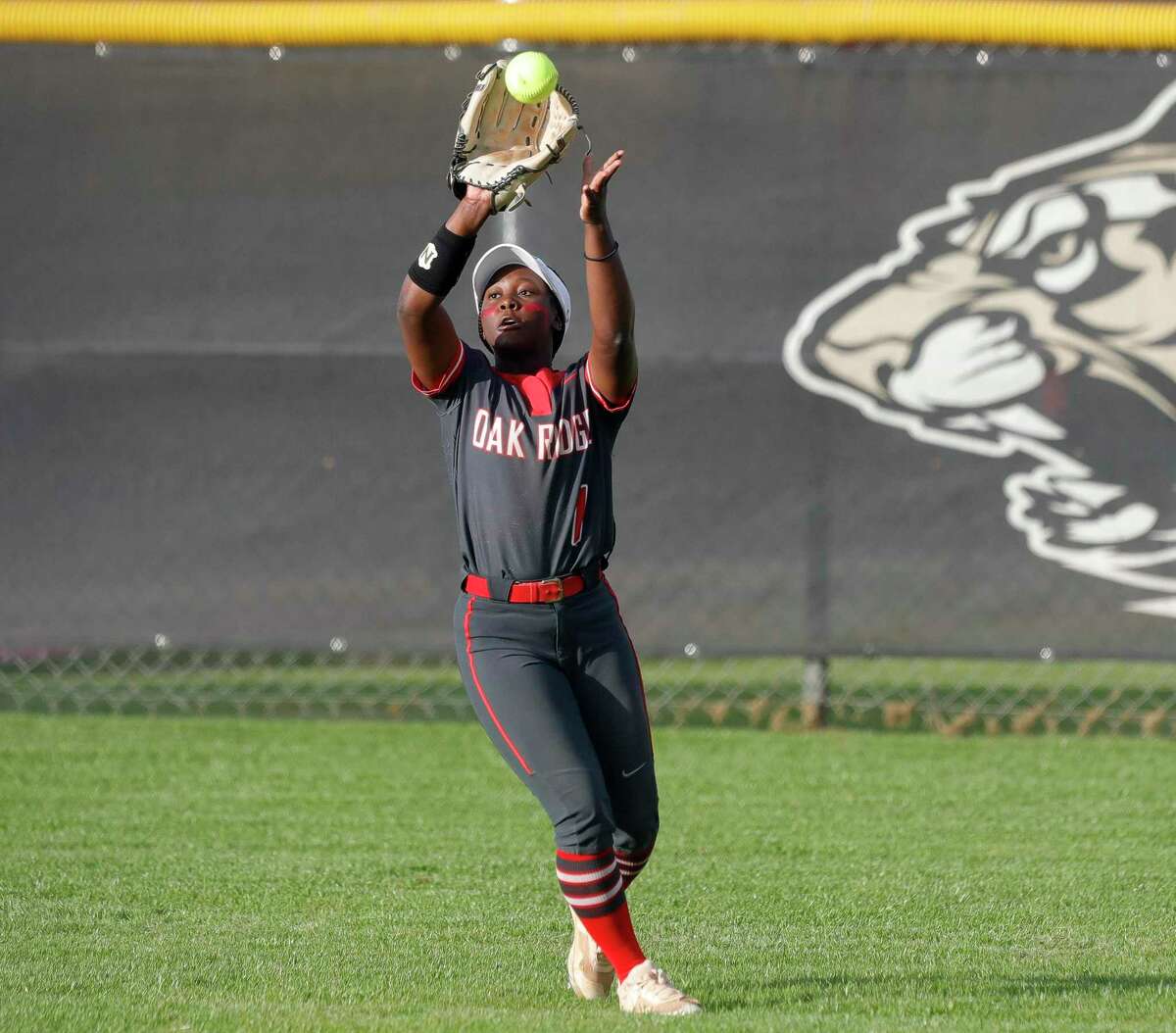 Oak Ridge center fielder Ariel Redmond (1) catches a fly ball in the third inning during a District 13-6A high school softball game at Conroe High School, Wednesday, March 23, 2022, in Conroe.