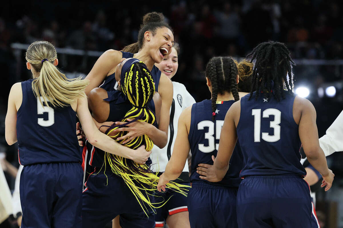 Olivia Nelson-Ododa and Aaliyah Edwards of the UConn Huskies hug after defeating the Stanford Cardinals 63-58 in the second half during the 2022 NCAA Women's Final Four semifinal game on April 01, 2022.