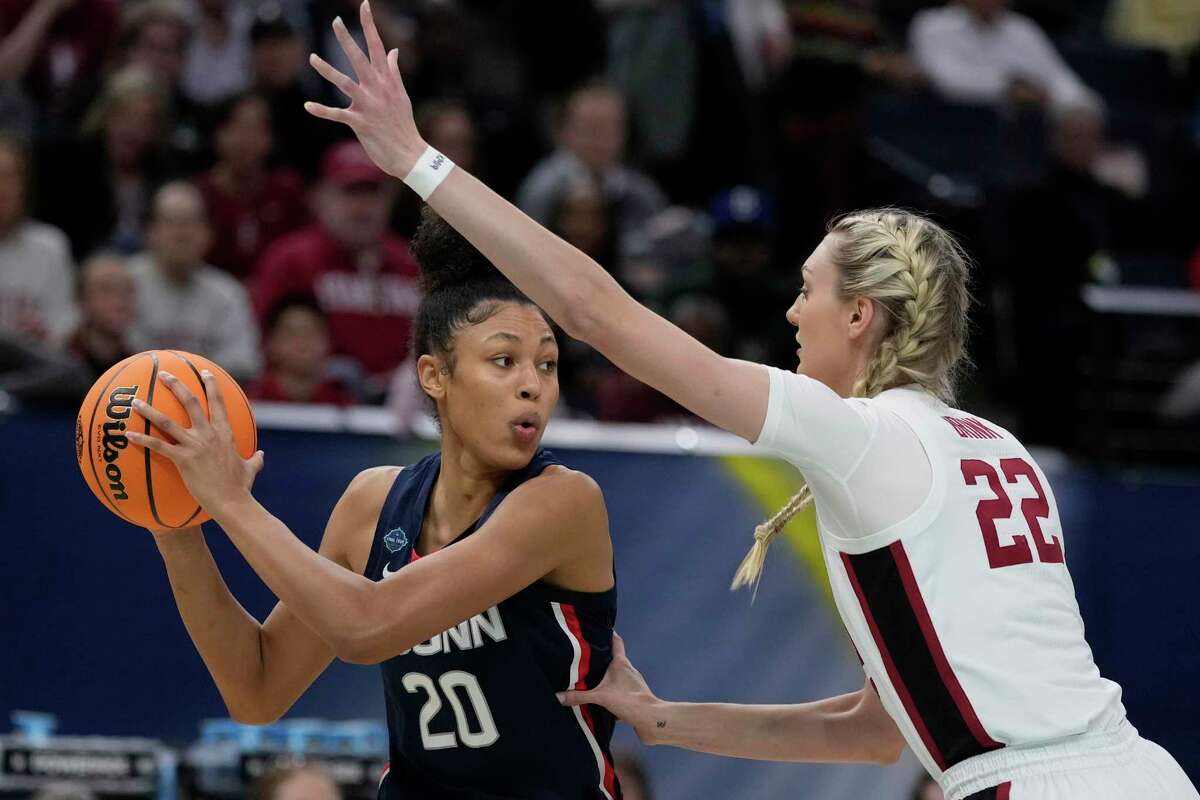 Stanford's Cameron Brink tries to stop UConn's Olivia Nelson-Ododa during the first half of a college basketball game in the semifinal round of the Women's Final Four NCAA tournament Friday, April 1, 2022, in Minneapolis. (AP Photo/Charlie Neibergall)