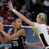 Stanford's Cameron Brink tries to stop UConn's Olivia Nelson-Ododa during the first half of a college basketball game in the semifinal round of the Women's Final Four NCAA tournament Friday, April 1, 2022, in Minneapolis. (AP Photo/Charlie Neibergall)