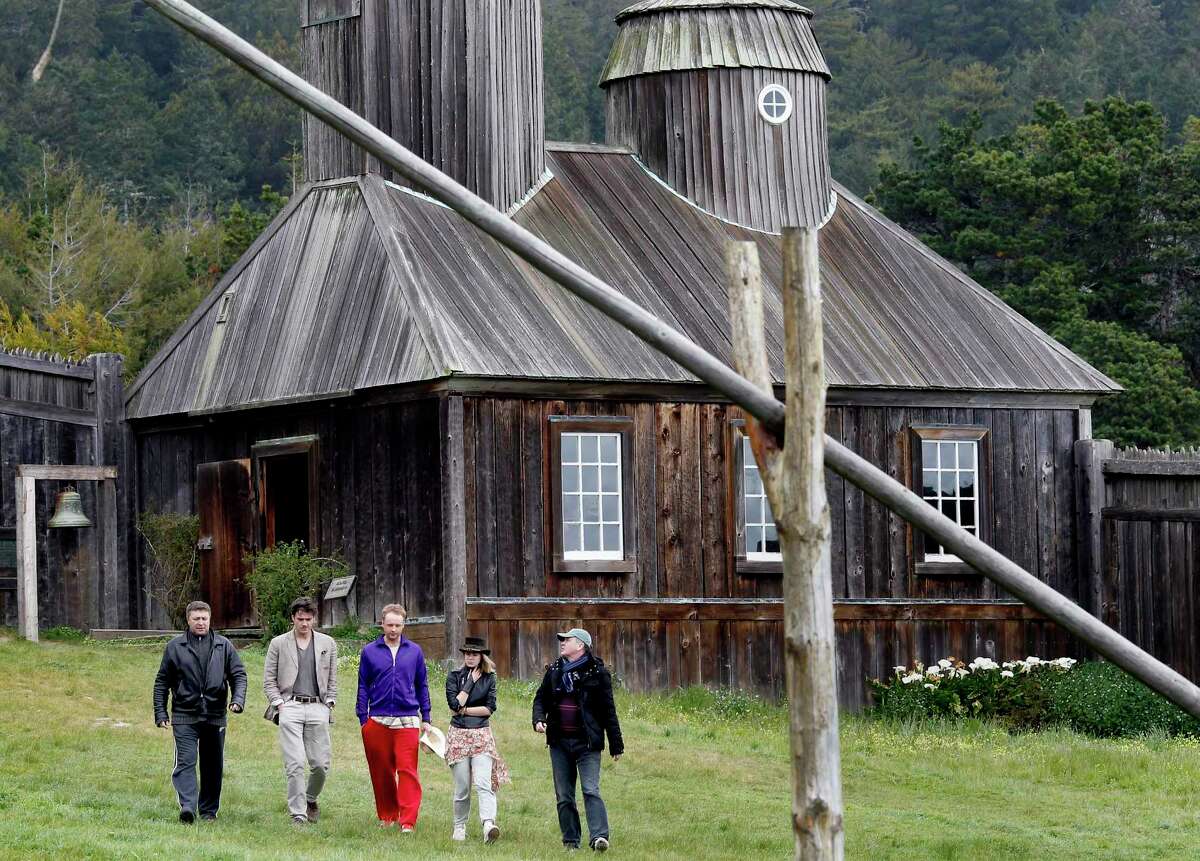 Members of a Russian movie crew walk past the chapel building at Fort Ross, a replica of the church that burned down in the 1960s. The crew was there in 2013 to produce a historical feature film about this southernmost Russian settlement in America.