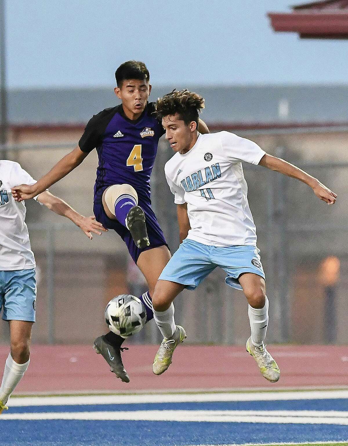 Lyndon B. Johnson High School’s Jonathan Figueroa and Harlan High School’s Edgar Paz-Torres go for the kick mid-air, Friday, April 1, 2022 at the UISD Student Activity Complex.
