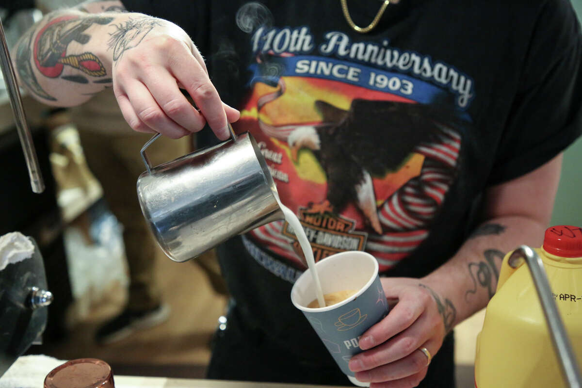 Logan Mulholland pours coffee during Free Coffee Day Friday, April 1, 2022 at Populace Coffee, which just opened its doors Monday in downtown Midland.