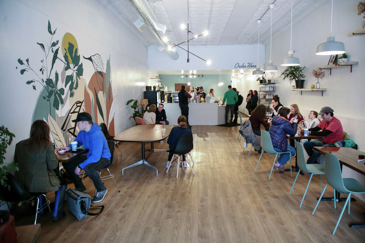 Patrons enjoy the atmosphere during Free Coffee Day Friday, April 1, 2022 at Populace Coffee, which just opened its doors Monday in downtown Midland.