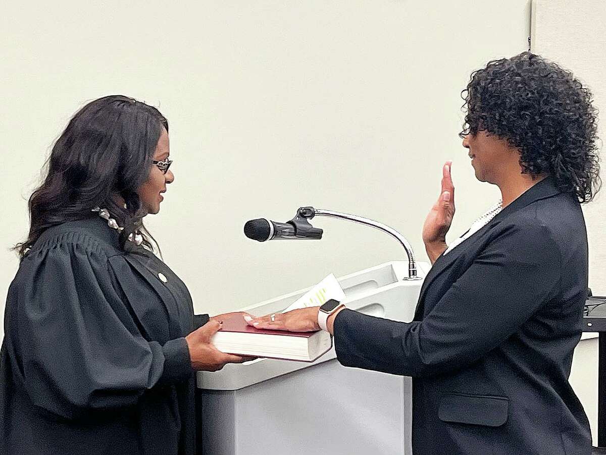 Karen Thomas raises her right hand as she takes the oath of office to serve the remaining term of her predecessor Tanya Eagleton at last week’s meeting of Crosby ISD trustees.