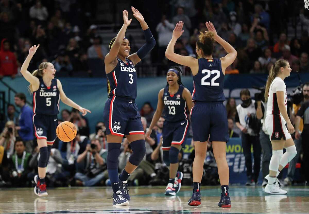 As Stanford?•s Hannah Jump walks away, UConn?•s Aaliyah Edwards (3), Evina Westbrook (220, Christyn Williams (13) and Paige Bueckers (5) celebrate their 63-58 win in NCAA Women?•s Basketball Final Four semifinal at Target Center in Minneapolis, MN on Friday, April 1, 2022.