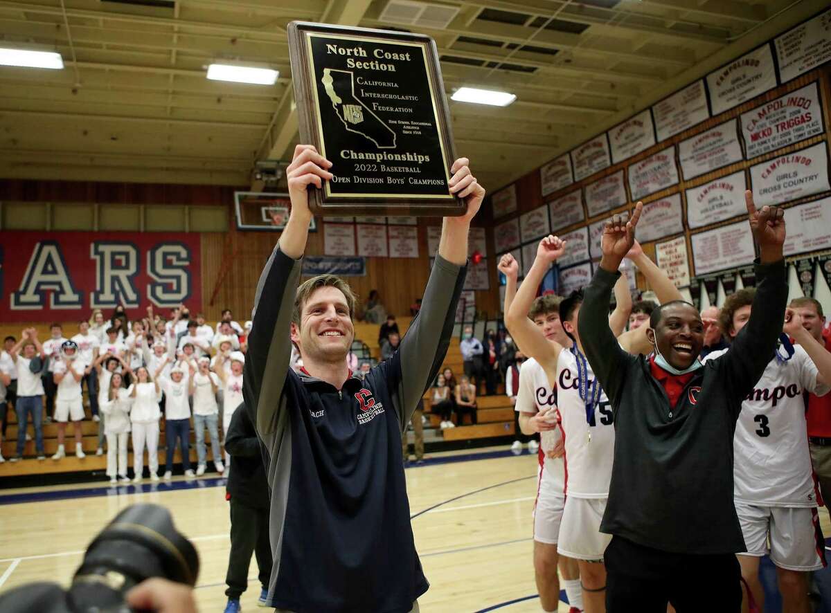 Campolindo boys basketball coach Steve Dyer celebrates after his team beat De La Salle to win the North Coast Section Open title.