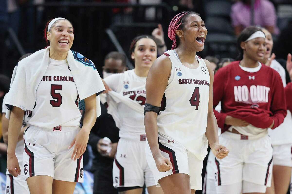 South Carolina's Aliyah Boston (4) and Victaria Saxton (5) celebrate with teammates in the second half against Louisville during an NCAA Tournament Final Four semifinal at Target Center on Friday, April 1, 2022, in Minneapolis. (Andy Lyons/Getty Images/TNS)