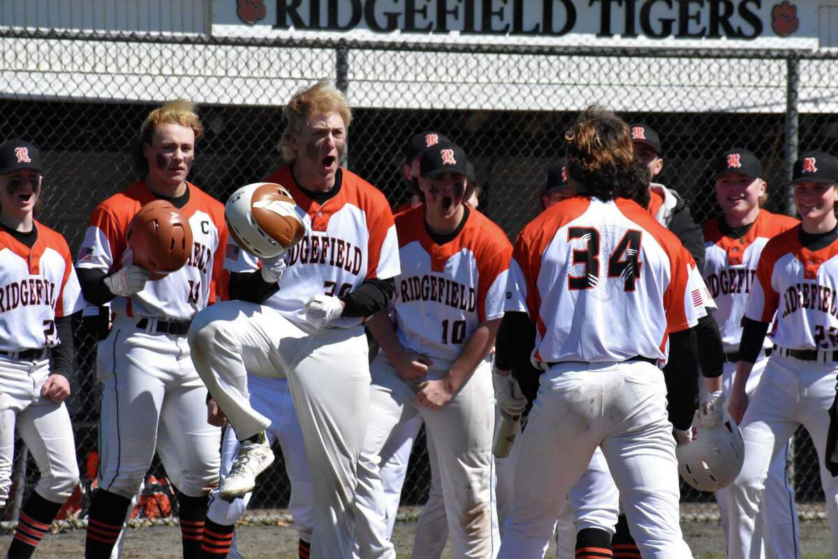 Ridgefield's Ben Cherico celebrates with Matthew Bucciero after his two-run home run during a baseball game between Ridgefield and Fairfield Prep at Govenor Field, Ridgefield on Saturday, April 2, 2022.