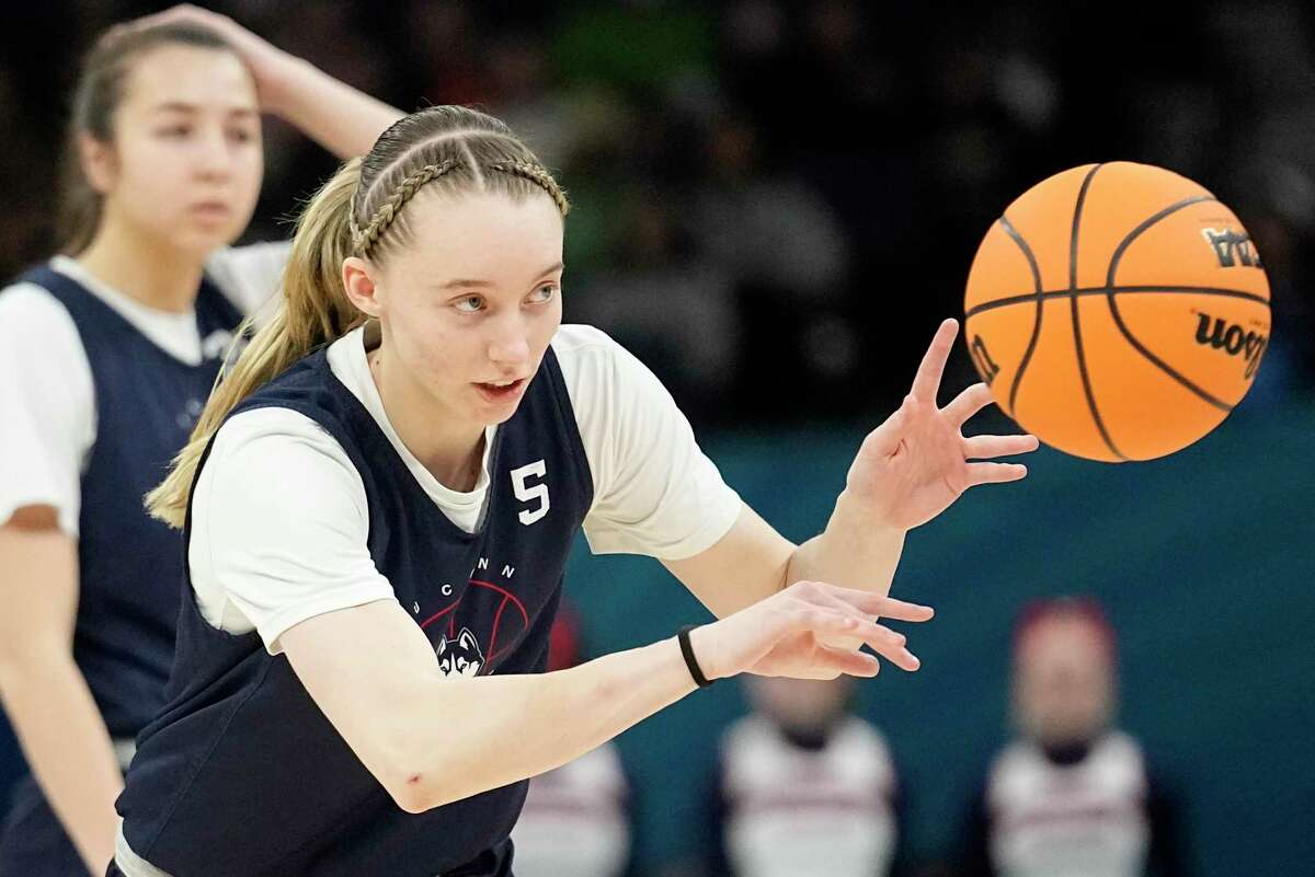 UConn's Paige Bueckers passes during a practice session for a college basketball game in the final round of the Women's Final Four NCAA tournament Saturday, April 2, 2022, in Minneapolis. (AP Photo/Eric Gay)