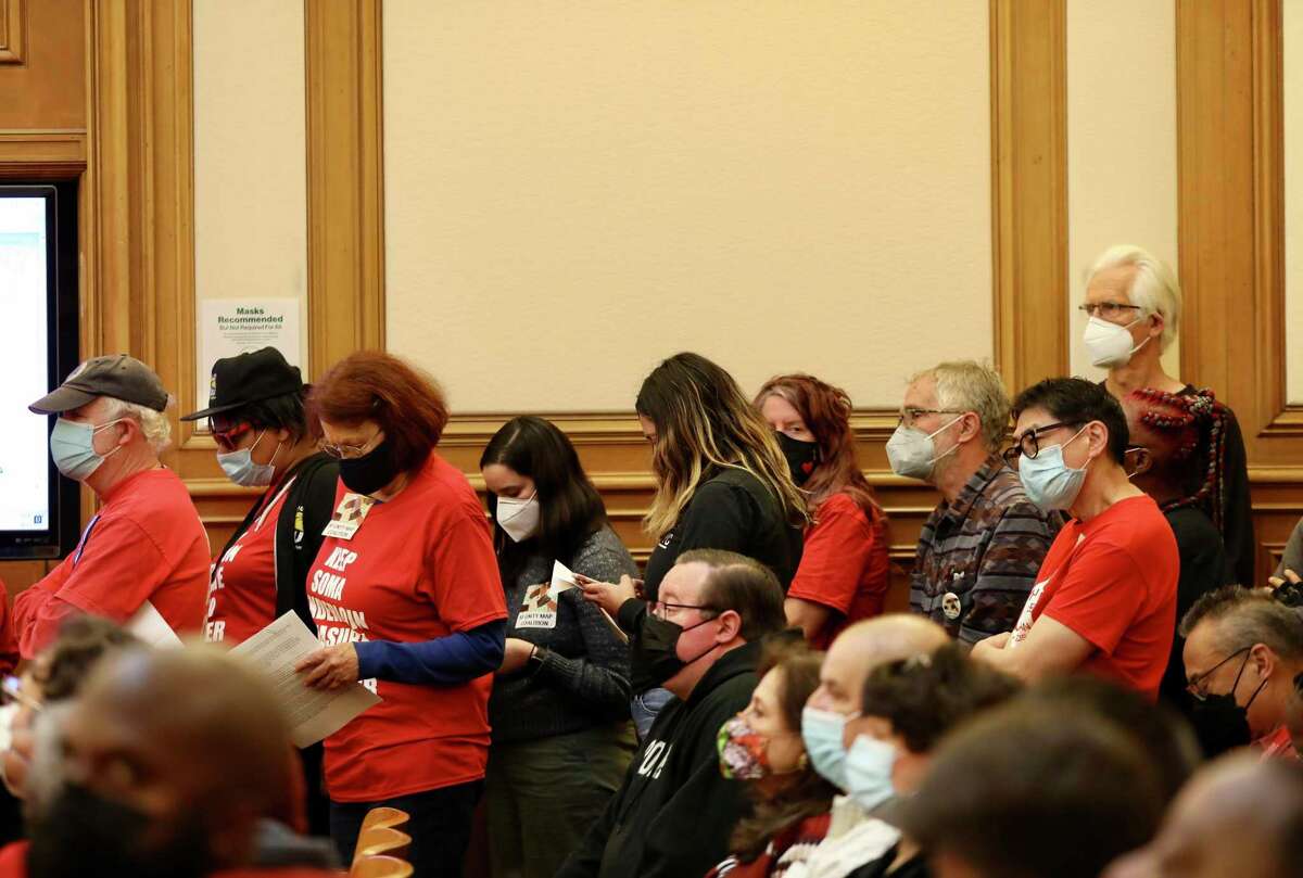 Concerned citizens line up to speak during a task force hearing at San Francisco City Hall on Saturday, April 2, 2022, in San Francisco, Calif. Folks are upset about a conversation splitting up District 6 between the Tenderloin and SOMA.