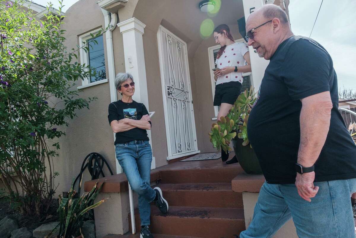Sharon Dolan (left), housemate Dylynn Barrows and Dolan’s ex-husband, Stefan Schneider, chat in front of Dolan’s house.