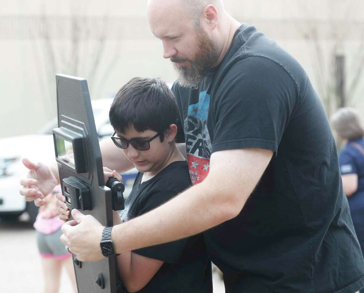 Rhys Hansen tries his hand at carrying a SWAT shield with the help of his dad, Josh, as The Montgomery County Sheriff's Office’s announced a new training program for raising awareness for autism, Saturday, April 2, 2022, in Conroe. The law enforcement agency partnered with Thrive Autism Foundation, a nonprofit formed to help children with autism gain access to individualized high-quality education, therapies, and other services.
