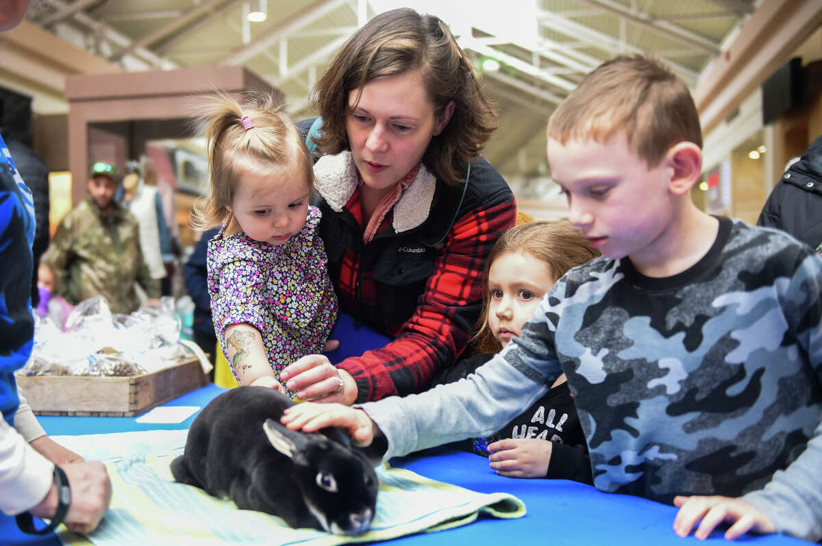 Children interact with rabbits during the Spring Fun with the Farm event hosted by Hopewell Ranch Saturday, April 2, 2022 at Midland Mall.