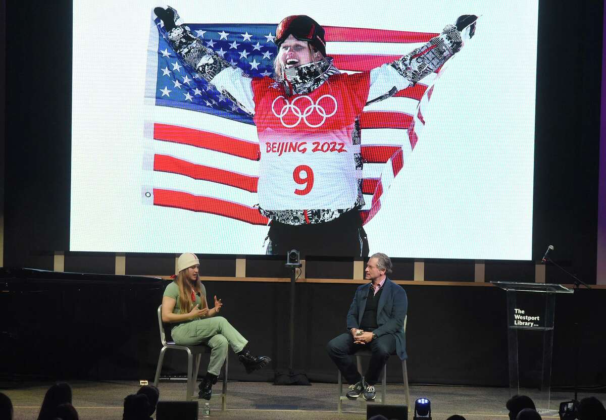 Westport's Julia Marino speaks with Jeremy Schaap during a celebration of Marino's Olympic silver medal in slopestyle snowboarding in Beijing, China, at the Westport Library on Saturday, April 2, 2022.