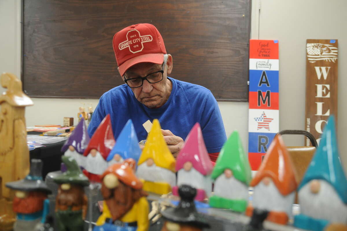Paul Shane carves more of his gnomes and hillbillies during Saturday's Small Business Extravaganza in Granite City.