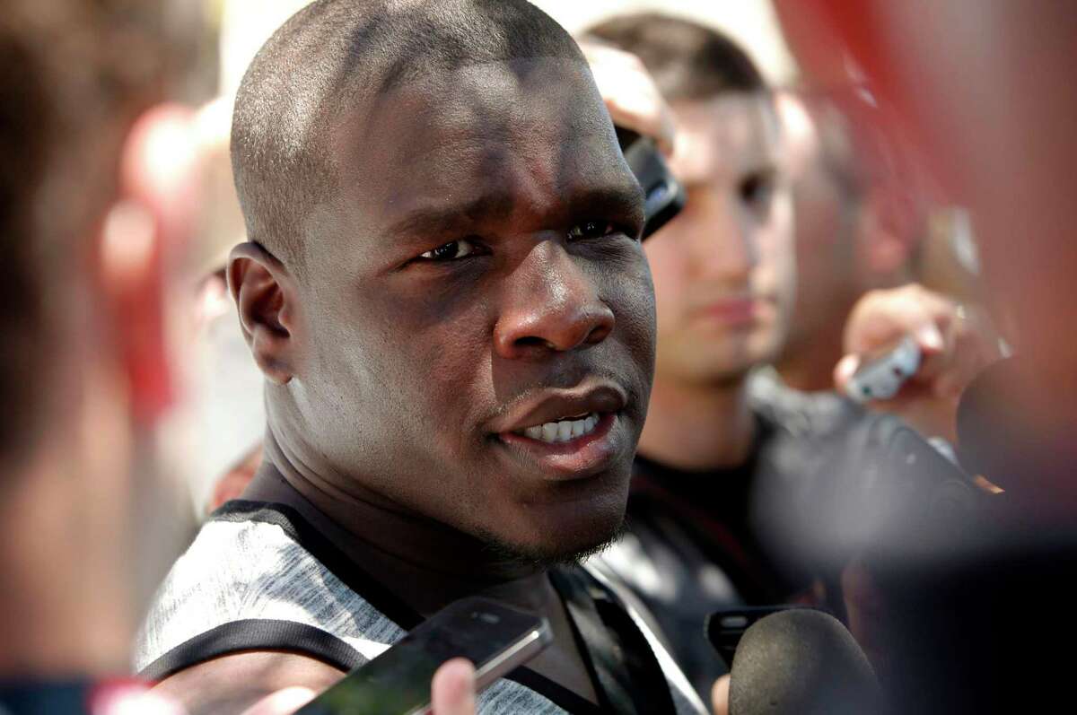 Running back Frank Gore, (21) talks with the news media as the San Francisco 49ers' veteran players reported to training camp today to prepare for the 2014 season at their practice facility in Santa Clara, Calif., as seen on Wednesday July 23, 2014.