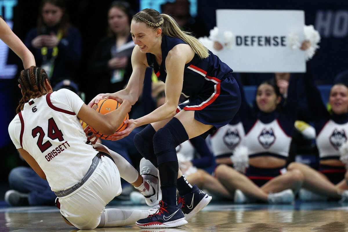 Paige Bueckers of the UConn Huskies and LeLe Grissett of the South Carolina Gamecocks battle for the ball during the second quarter during the 2022 NCAA Women's Basketball Tournament National Championship game at Target Center on April 03, 2022 in Minneapolis, Minnesota.