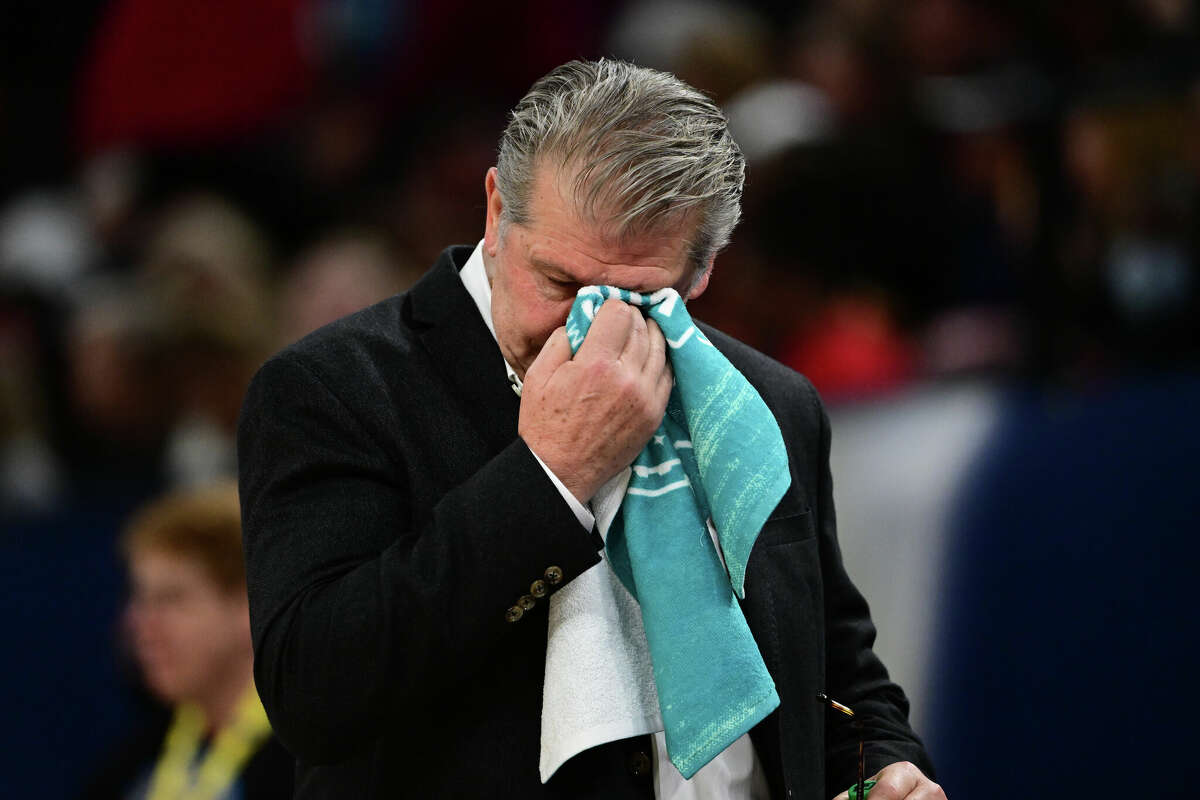 Head coach Geno Auriemma of the Connecticut Huskies wipes his face as they play the South Carolina Gamecocks during the championship game of the NCAA Women's Basketball Tournament at Target Center on April 3, 2022 in Minneapolis, Minnesota.