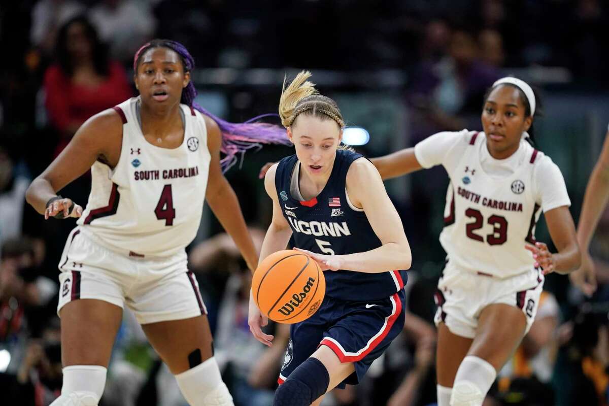 UConn’s Paige Bueckers looks to get past South Carolina’s Aliyah Boston and Bree Hall during Sunday night’s national championship at the Target Center in Minneapolis.