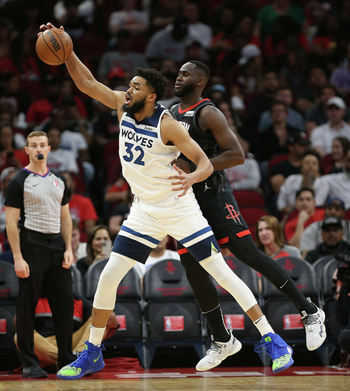 HOUSTON, TEXAS - APRIL 03: Karl-Anthony Towns #32 of the Minnesota Timberwolves received the ball as he is guarded by Usman Garuba #16 of the Houston Rockets during the second quarter at Toyota Center on April 03, 2022 in Houston, Texas. NOTE TO USER: User expressly acknowledges and agrees that, by downloading and or using this photograph, User is consenting to the terms and conditions of the Getty Images License Agreement. (Photo by Bob Levey/Getty Images)